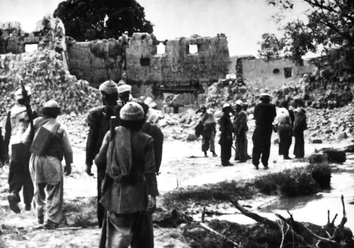 Afghan resistance fighters return to a village destroyed by Soviet forces