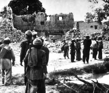 Afghan resistance fighters return to a village destroyed by Soviet forces